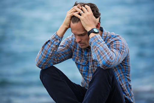Wellbrook Recovery explains why people do drugs through a man holding his head in his hands