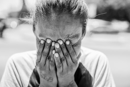 Wellbrook Recovery shows a woman with her face in her hands to represent addiction denial