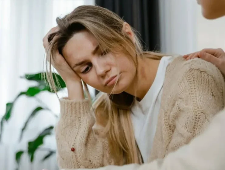 Distressed woman receiving Internal Family Systems Therapy (IFS) for addictions during a supportive session.