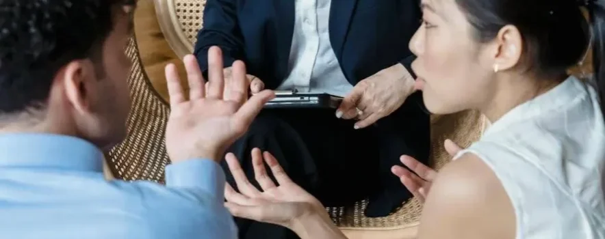 Therapist listens as a couple discusses the significant impact and repercussions of family roles in addiction.