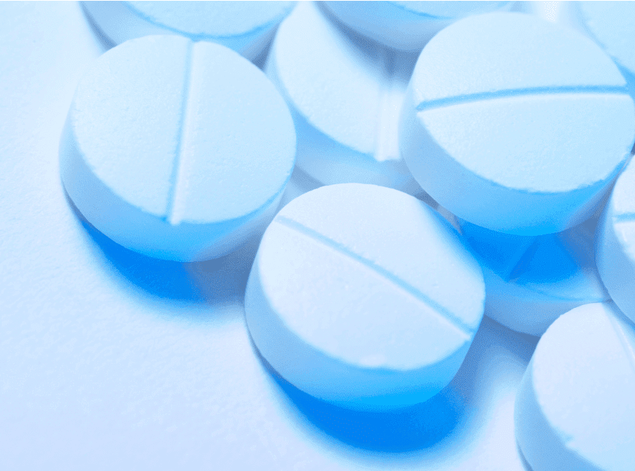 A cluster of blue Adderall pills, used to improve focus. Learn how to manage Adderall withdrawal.