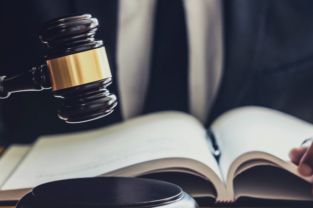A judge’s gavel rests beside a law book, symbolizing the legal authority behind rehab confidentiality laws.