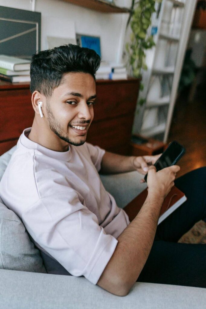 Man enjoying music in a rehab that allows cell phones during downtime for relaxation and healing.