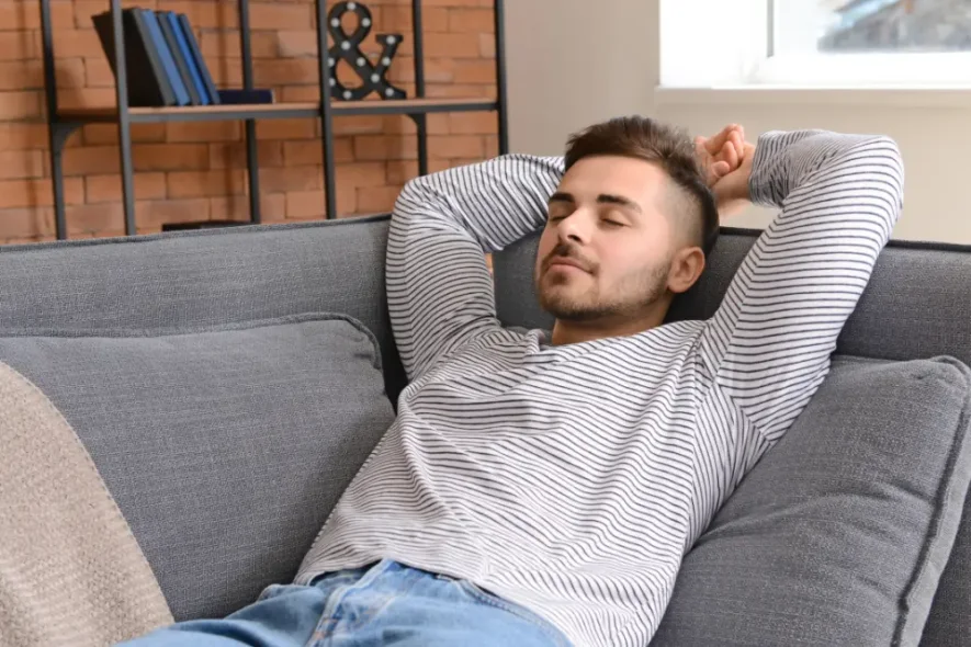 Man lying down during trauma therapy session for addiction emphasizing relaxation, grounding, and nervous system regulation.