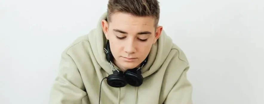 Boy in rehab using phone, illustrating the common question: Can you have your phone in rehab?