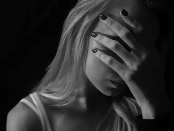 Trauma and addiction shown through a woman's emotional distress, highlighting how trauma therapy supports recovery