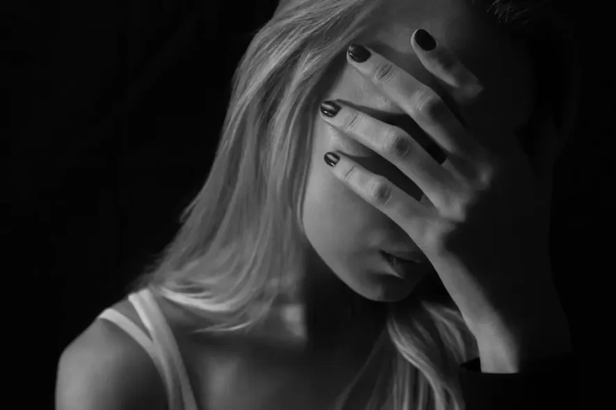 Trauma and addiction shown through a woman's emotional distress, highlighting how trauma therapy supports recovery