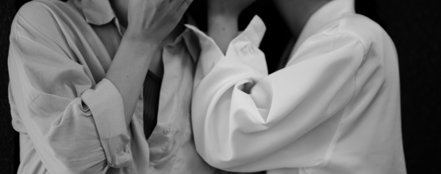 Two individuals whisper in private, symbolizing the importance of confidentiality and trust in rehab settings.