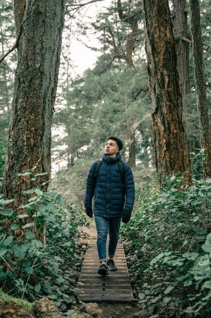 Man taking a walk through nature to help stress management during the alcohol detox process.