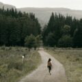 Woman walking down a forest road, symbolizing recovery and the question, “How many people relapse after rehab?”