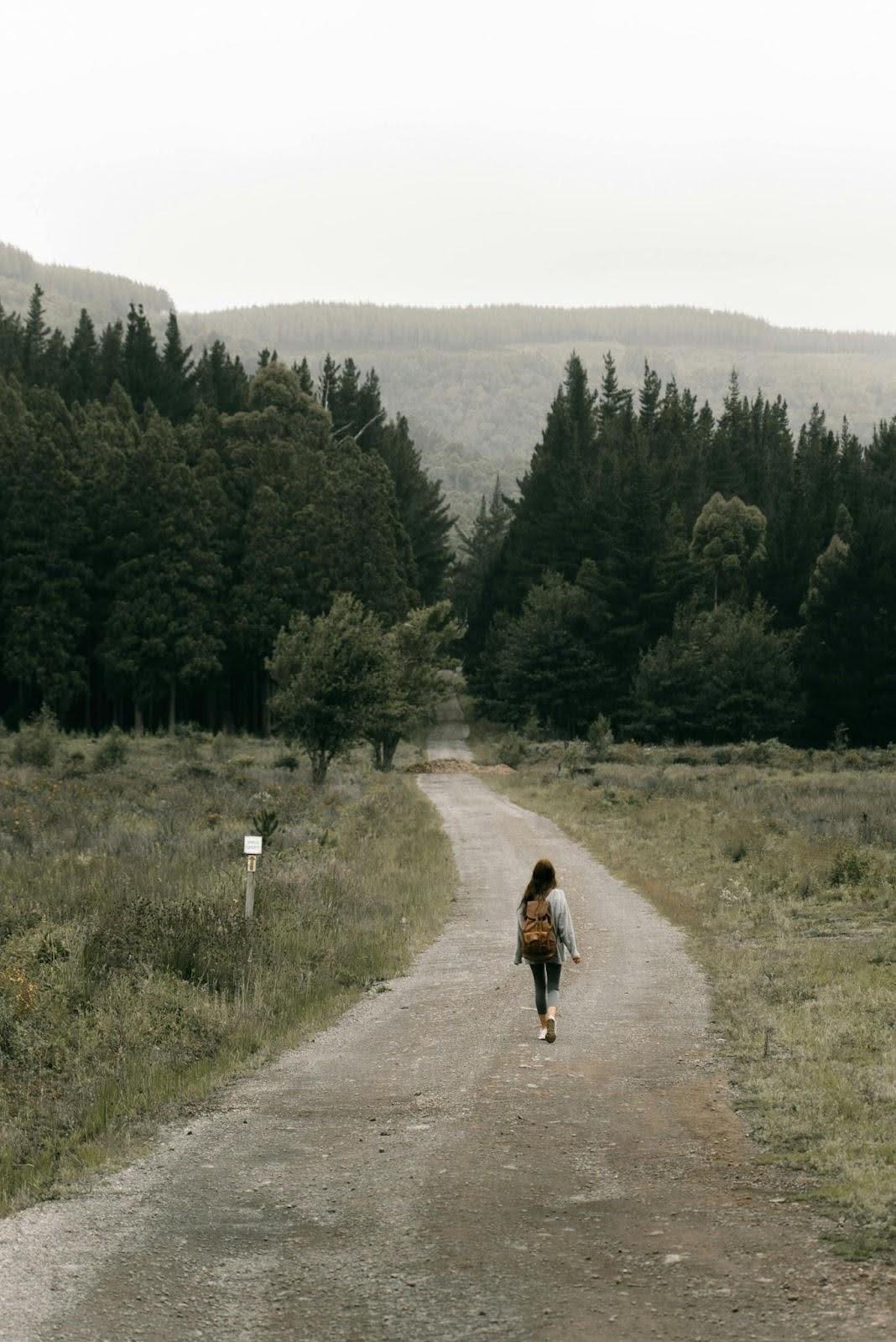 Woman walking down a forest road, symbolizing recovery and the question, “How many people relapse after rehab?”