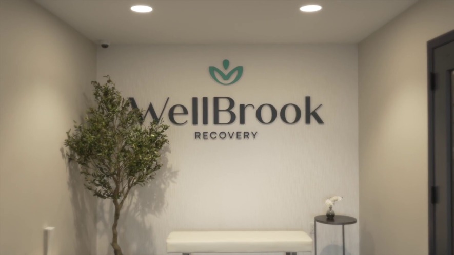 WellBrook Recovery sign and logo on wall. We can help navigate life after rehab.