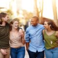 four friends walking outside together having a good time