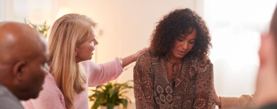group-consoling-woman-speaking-at-support-group