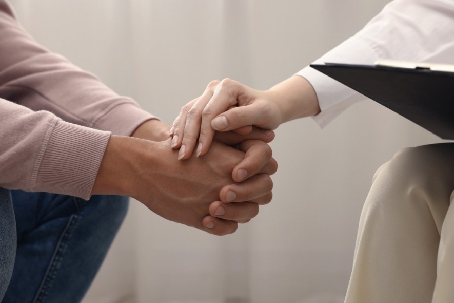holding patients hand