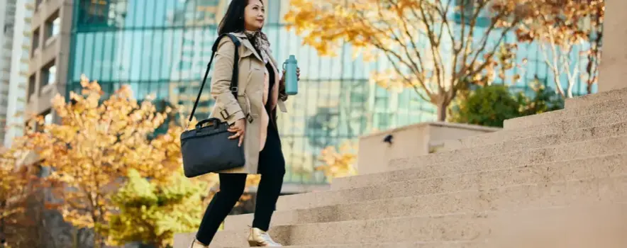 businesswoman-walking-up-city-steps