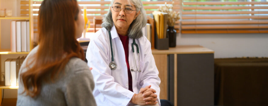 Senior female psychologist listening to female patient during a session in her office. Mental health concept.