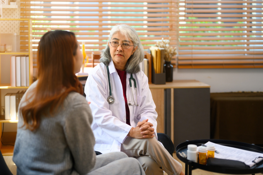 Senior female psychologist listening to female patient during a session in her office. Mental health concept.