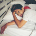 man-lying-in-bed-with-a-headache-2026-03-26-07-19-35-utc