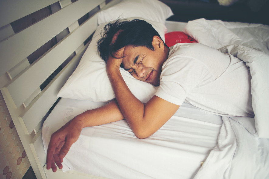 man-lying-in-bed-with-a-headache-2026-03-26-07-19-35-utc